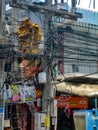 THAILAND, PHUKET - MARCH 26, 2012: Chaos of cables and wires on an electric pole. Wire and cable clutter