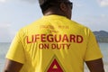 Thailand, Phuket, March 30, 2020: duty lifeguard, large inscription on the back of the t-shirt of a Thai man. He looks