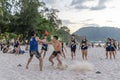 Thailand, Phuket, March 30, 2020: men and teenage girls from China play soccer and Rugby with a ball on the beach. sharp fighting Royalty Free Stock Photo