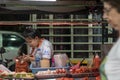 Thailand, Phuket, Patong, February 1, 2020: a female street food vendor looks at her phone. night street photos, passers