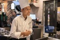 Thailand, Phuket, Patong. January 3, 2020: A young chef smiles as he accepts a customer order at a Japanese Tepanyaki