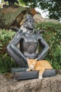 Thailand Siamese Cat Sleeping Nearby a Buddha Statue Royalty Free Stock Photo