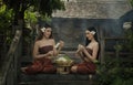 Thailand women in traditional dress sitting for made of flower garlands.