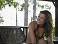 Thailand young woman wearing bikini relaxing in chair portrait