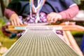 Closeup and crop fabric on blurred Thailander Hill tribe old ladies are weaving Royalty Free Stock Photo