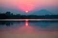 Thailands serene lake reflects vibrant hues of the setting sun