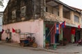 Traditional tuk-tuk in Laos along wall on the street