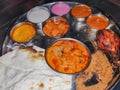 A Thali from kolhapur Maharashtra Indian traditional food with red and  white  gravies to be served with meat Royalty Free Stock Photo