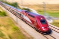 A Thalys high speed train at full speed in the countryside with motion blur