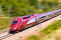 A Thalys high speed train at full speed in the countryside with motion blur