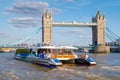 Thames Clipper catamaran next to the Tower Bridge on the river Thames in London