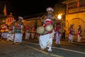 A Thammattam Player (centre) leads a group of Davul Players performing at the Esala Perahara in Kandy, Sri Lanka.