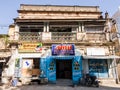 An old decaying shophouse with ornate balconies, railing and balustrades on the