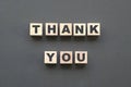 Thank you alphabet letters on wooden blocks on dark grey background Royalty Free Stock Photo