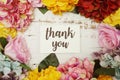 Thank you Card with colorful flowers border frame on wooden background Royalty Free Stock Photo