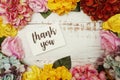 Thank you Card with colorful flowers border frame on wooden background Royalty Free Stock Photo