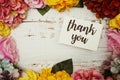 Thank you Card with colorful flowers border frame on wooden background Royalty Free Stock Photo