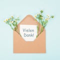 Thank you card in an envelope surrounded by flowers, being thankful, support, help and charity concept, positive attitude Royalty Free Stock Photo