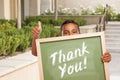 Thank You Chalk Board Held by Hispanic Boy Giving Thumbs Up Royalty Free Stock Photo