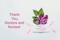 Thank You Doctor and Nurses concept with medical mask and lilac flowers