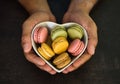 Thank you gift with colorful macaroons inside a heart shaped box on dark background Royalty Free Stock Photo