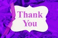 Thank you gift tag over colorful purple glossy paper Royalty Free Stock Photo