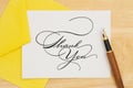 Thank You greeting card in yellow envelop with pen Royalty Free Stock Photo