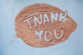Thank You Hand Written Text On Sand Surface In Shape Of Leaf. Top View. Colorful Sand. Spring Expectation Concept