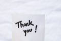 Thank you handwriting text close up isolated on white paper with copy space. Writing text on memo post reminder Royalty Free Stock Photo