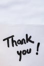 Thank you handwriting text close up isolated on white paper with copy space. Writing text on memo post reminder Royalty Free Stock Photo