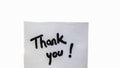 Thank you handwriting text close up isolated on white paper with copy space. Writing text on memo post reminder