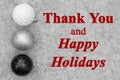 Happy Holidays greeting with black and white ball ornaments on gray felt