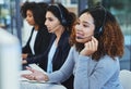 Thank you for holding, how may I assist. young women working in a call centre. Royalty Free Stock Photo