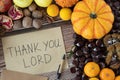 Thank You, LORD, handwriting on an old vintage paper with pen and various autumn fruit on wooden background, top view