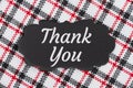 Thank you message on a chalkboard label on plaid material