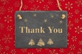 Thank you message on a chalkboard sign with snowflakes