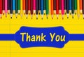 Thank you message with color pencils crayons on yellow ruled line notebook paper Royalty Free Stock Photo