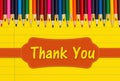 Thank you message with color pencils crayons on yellow ruled line notebook paper Royalty Free Stock Photo