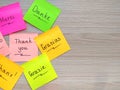 Thank you message on different languages on sticker note on wooden background