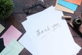 Thank you message and envelope on wooden table Royalty Free Stock Photo