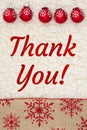 Thank you message with red and brown snowflake border with ornaments on sherpa