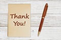 Thank you message on retro old yellowed paper notepad with a pen Royalty Free Stock Photo