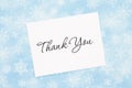 Thank you message with white greeting card with a blue snowflake