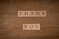 Thank you message on wooden blocks on rustic table Royalty Free Stock Photo