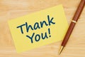 Thank you message on yellow paper index card with pen Royalty Free Stock Photo