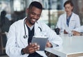 Thank you for messaging me. a young male doctor taking a break and using his digital tablet. Royalty Free Stock Photo
