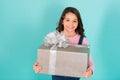 Thank you so much. Child happy face holds big gift box turquoise background. Kid girl delighted gift. Girl curly Royalty Free Stock Photo