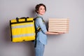 Thank you for order. Photo of cheerful lady hold stack pizza boxes delivery quarantine receiving big yellow backpack