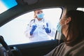 Thank you for playing your part. a masked young doctor giving a patient an injection at a Covid-19 drive through testing Royalty Free Stock Photo