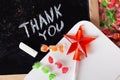Thank you Space written on a blackboard with chalk, caramel, candy, star, wand, valentines day, sweet tooth lollipop door sign Royalty Free Stock Photo